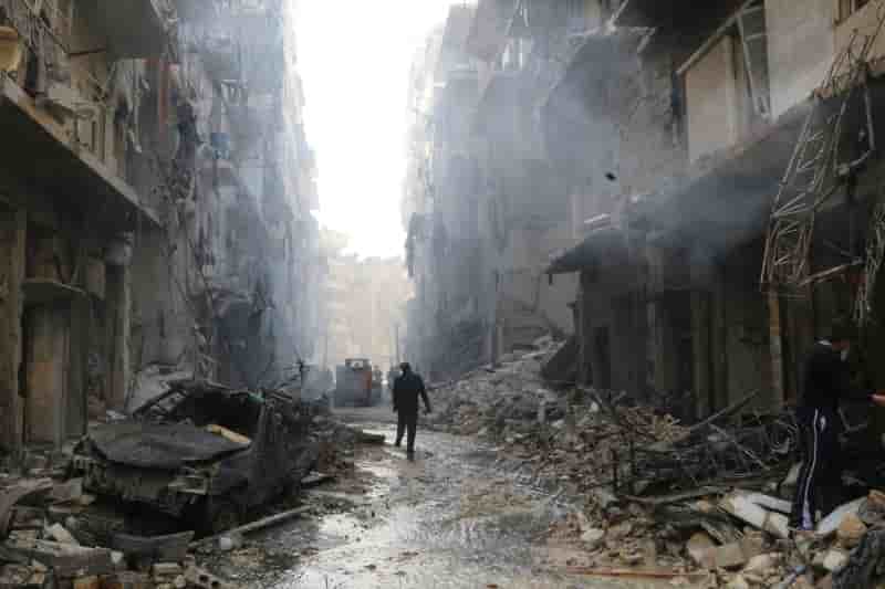 People inspect damage at a site hit by what activists said were barrel bombs dropped by forces loyal to syria's president al-assad in aleppo's district of al-sukari