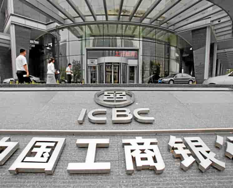 Pedestrians walk past a branch of the Industrial and Commercial Bank of China (ICBC) Ltd., in Beijing, China, on Thursday, July 29, 2010. ICBC, the world's largest lender by market value, said it will raise up to 45 billion yuan ($6.6 billion) in a rights offer to replenish capital. Photographer: Ne