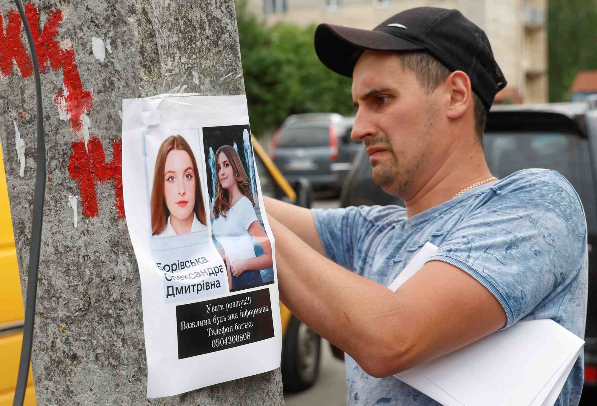 Photo d'archives d'un homme posant une affiche sur une personne disparue, a vinnytsia
