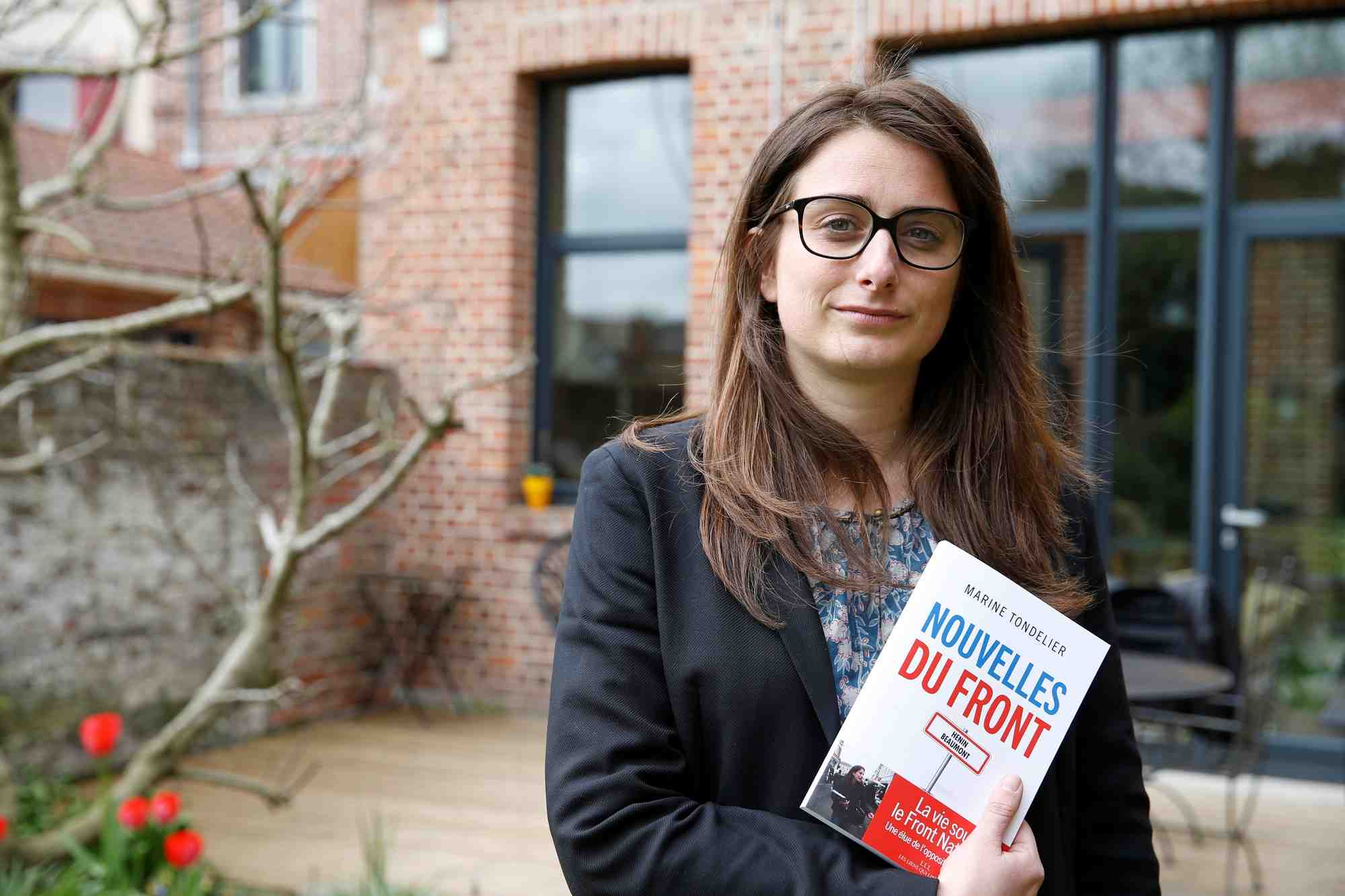 Marine tondelier dans son jardin a henin-beaumont en france, tenant son livre "nouvelles du front"