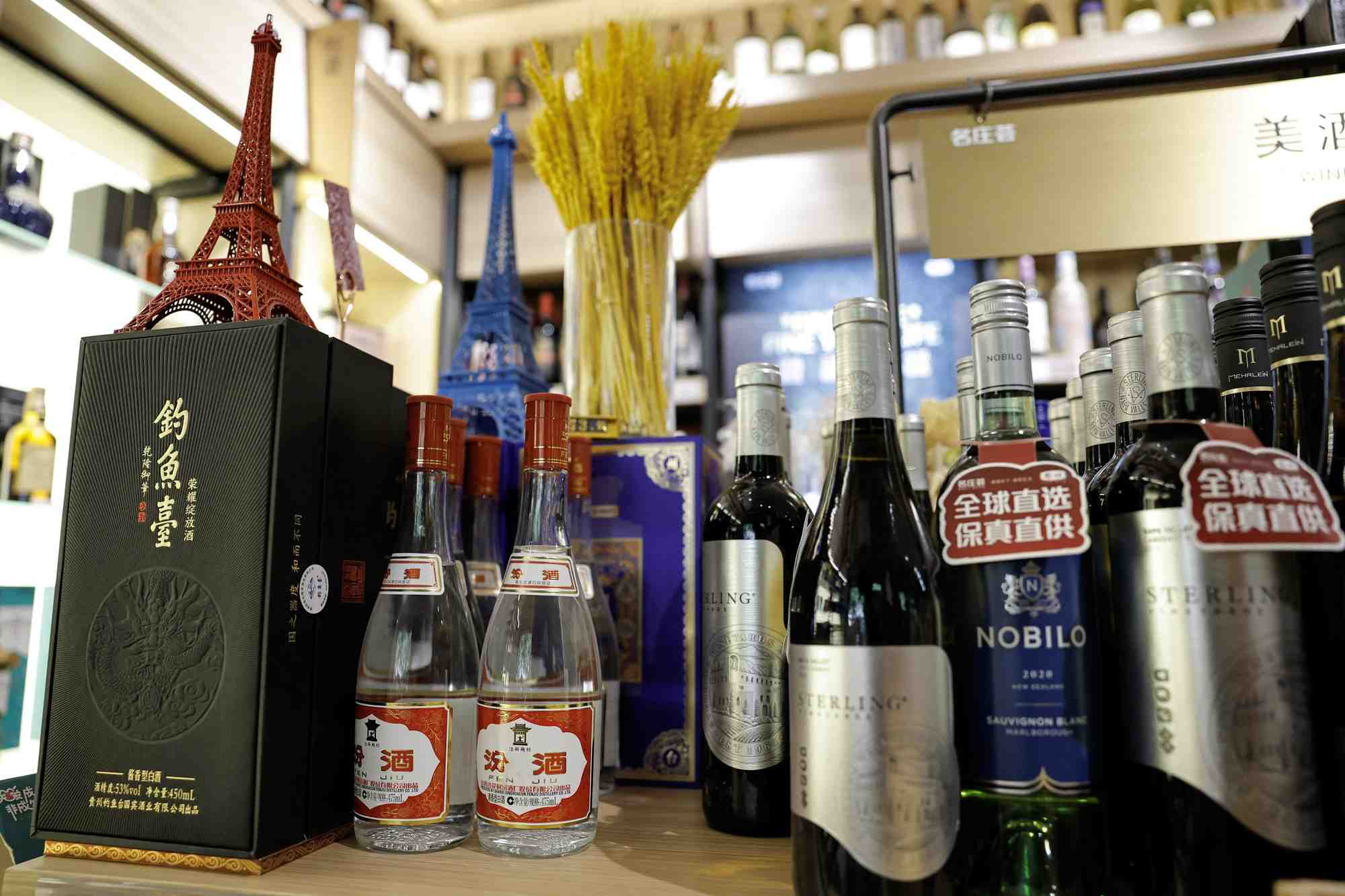 Chinese spirit baijiu are displayed next to bottles of wine inside a liquor store in beijing