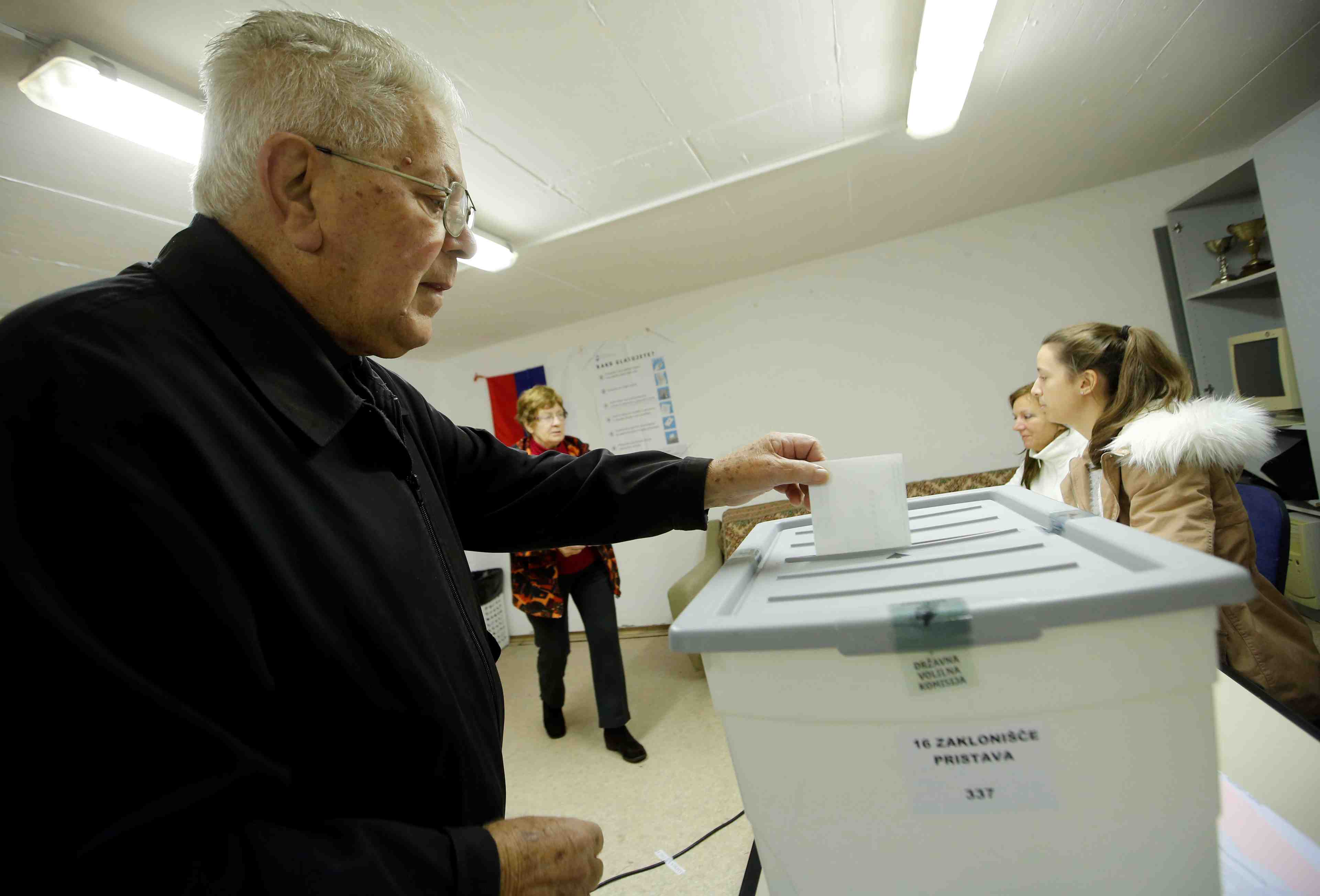 A man casts his ballot at a polling station during the second round of the presidential election in nova gorica