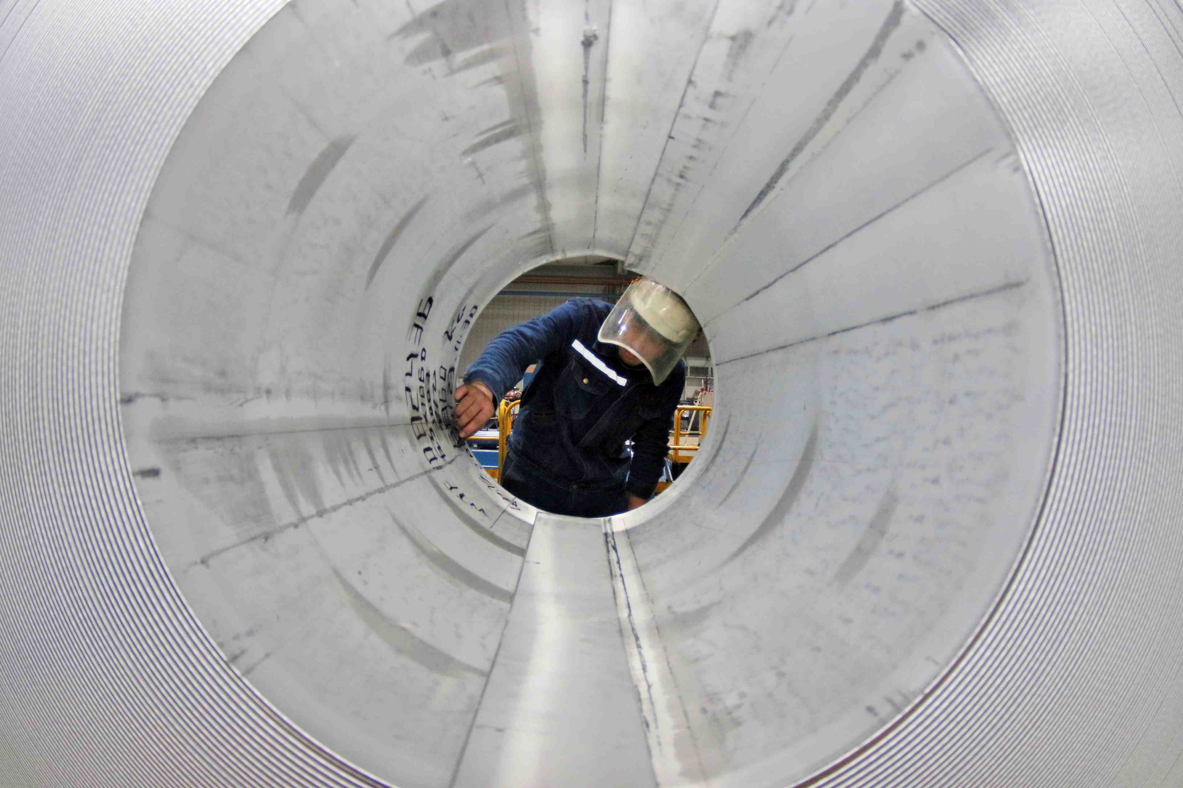 Employee works at the production line of aluminium rolls at a factory in zouping