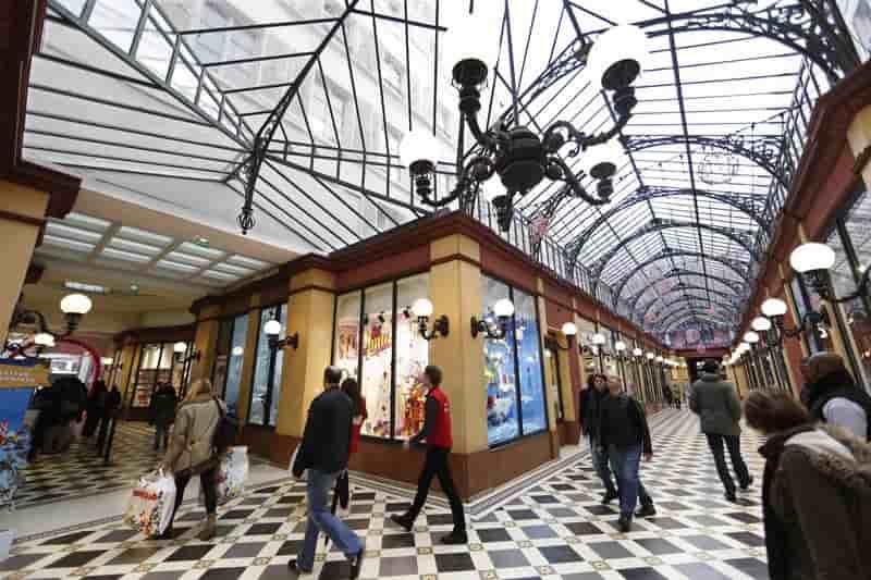 Visitors walk inside the passage des princes, a covered arcade which houses numerous shops dedicated to toys, in paris