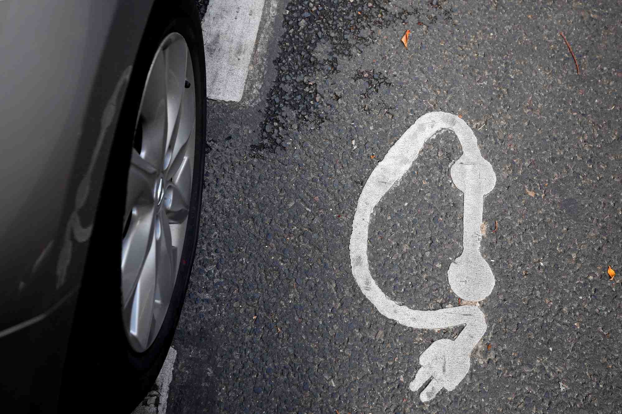 Un symbole est photographie a cote d'une borne de recharge de voiture electrique dans une rue de paris