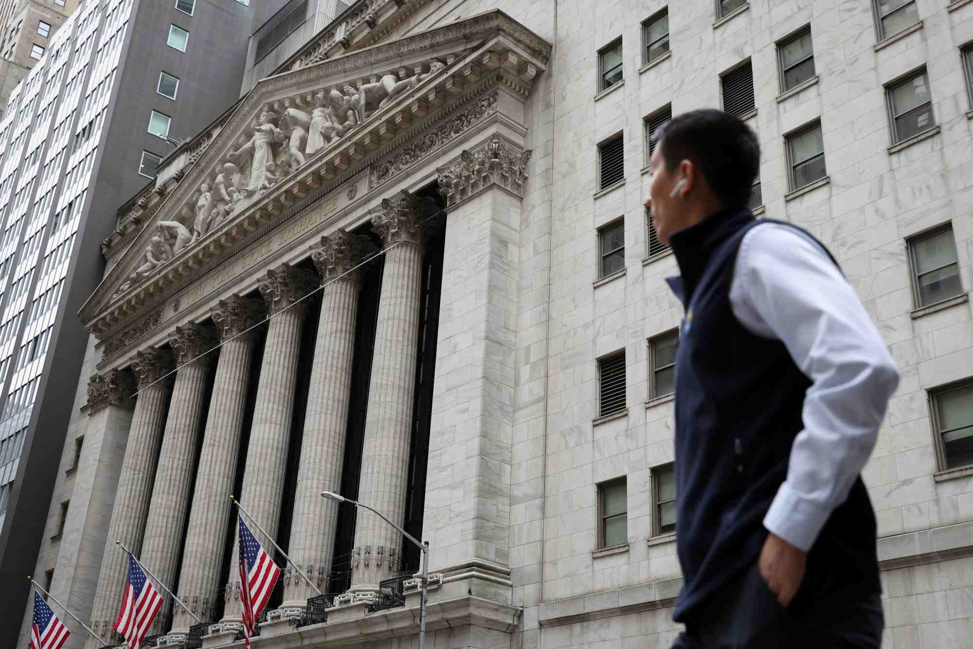 A person walks by the new york stock exchange (nyse) in manhattan, new york city