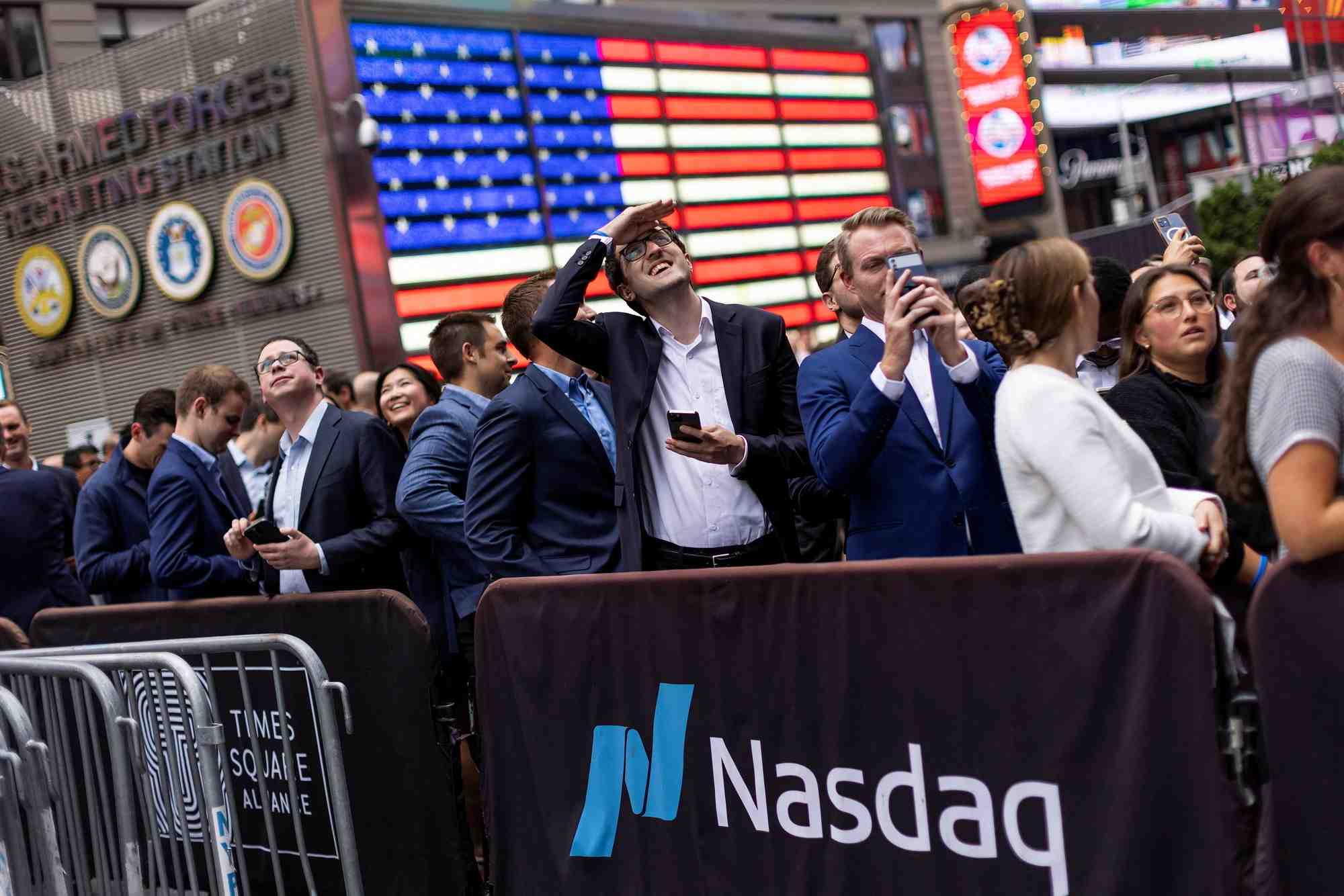 Des personnes observent le batiment du nasdaq a times square a new york