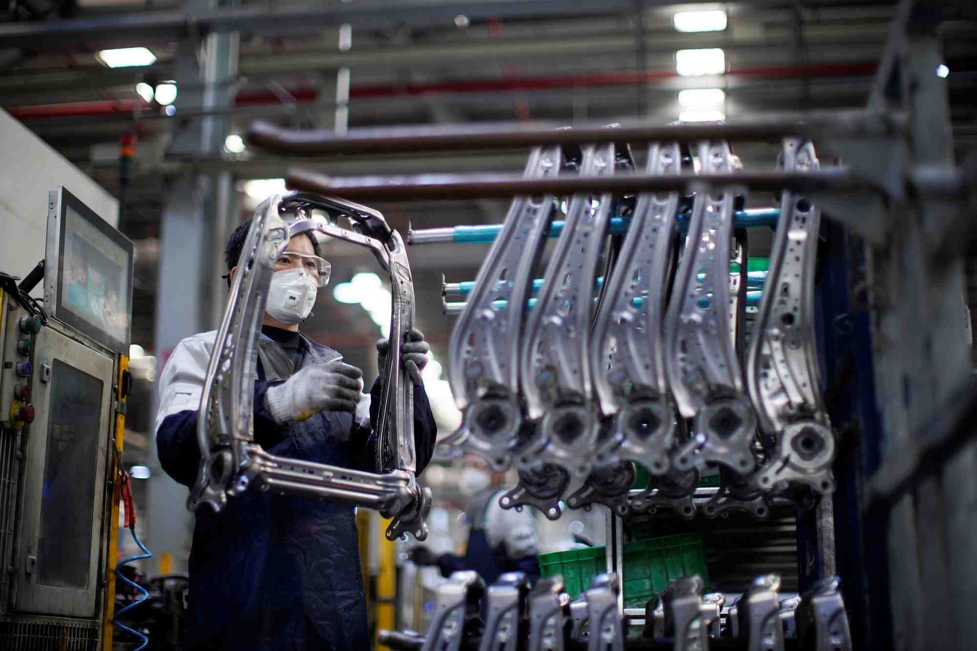 Un employe travaille sur une chaine de montage de sieges de voiture a l'usine yanfeng adient de shanghai, en chine