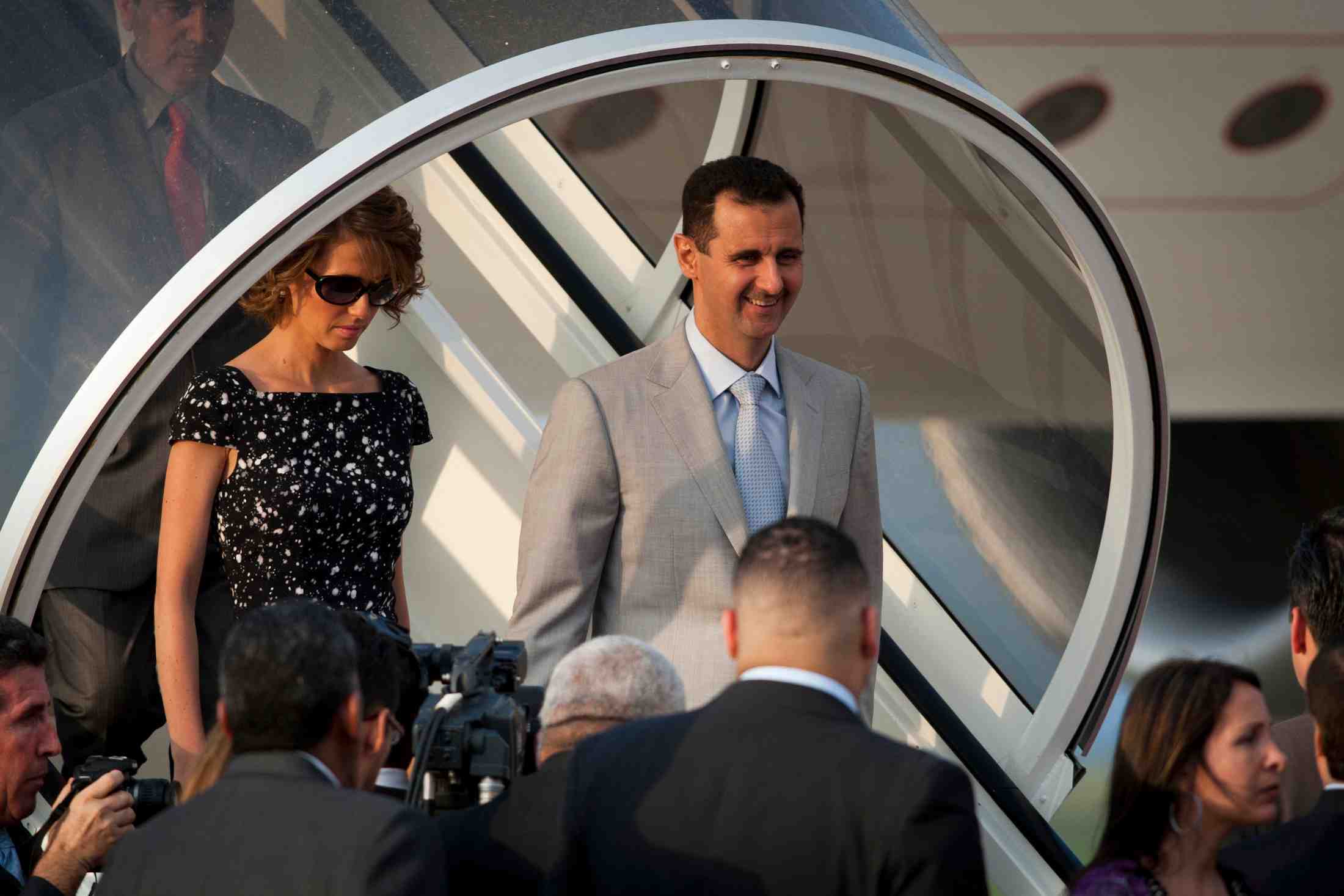 Syria's president assad and his wife asma disembark from a plane as they arrive for an official visit in caracas