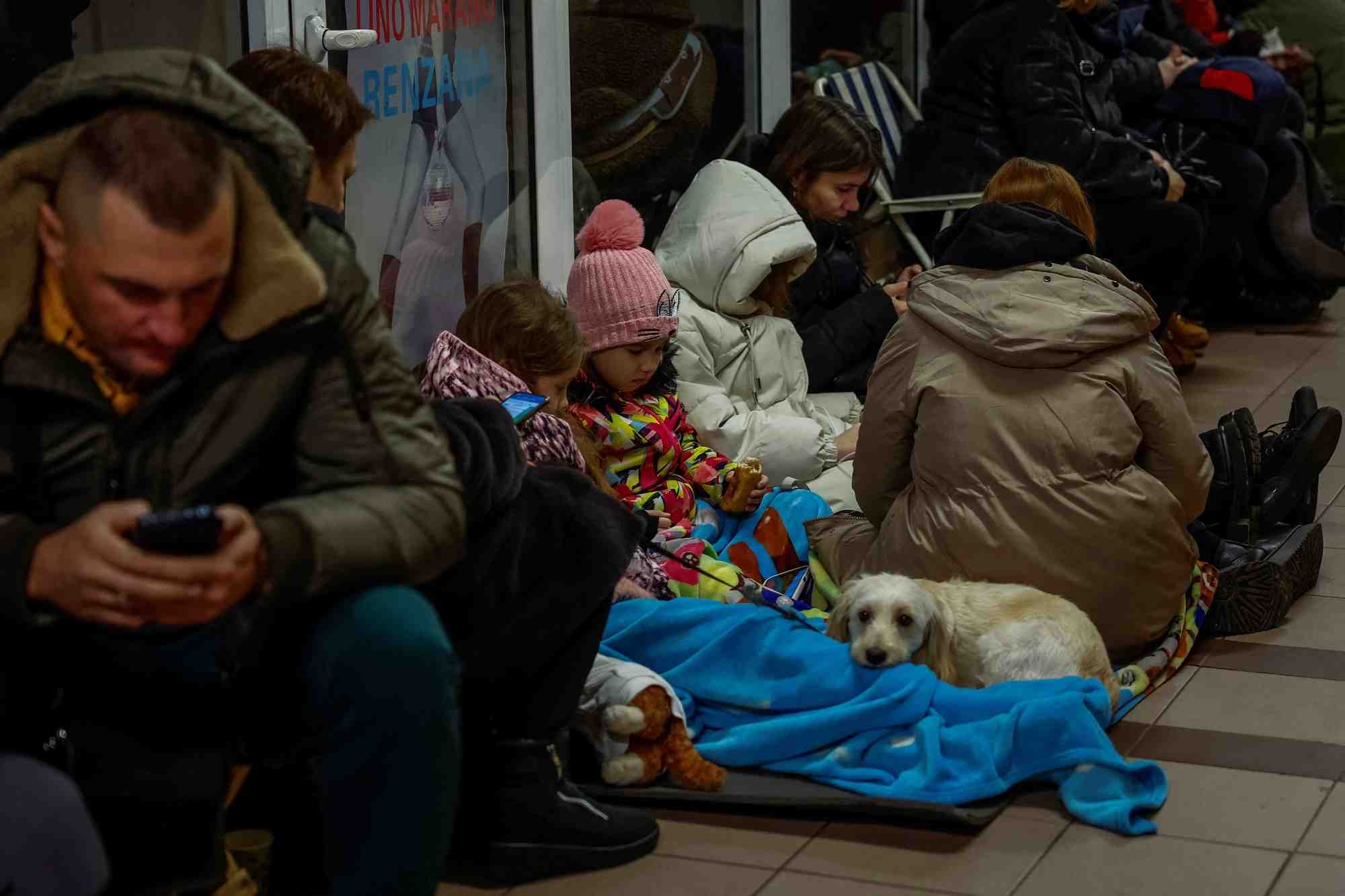 People take shelter inside a metro station during a russian military attack, in kyiv