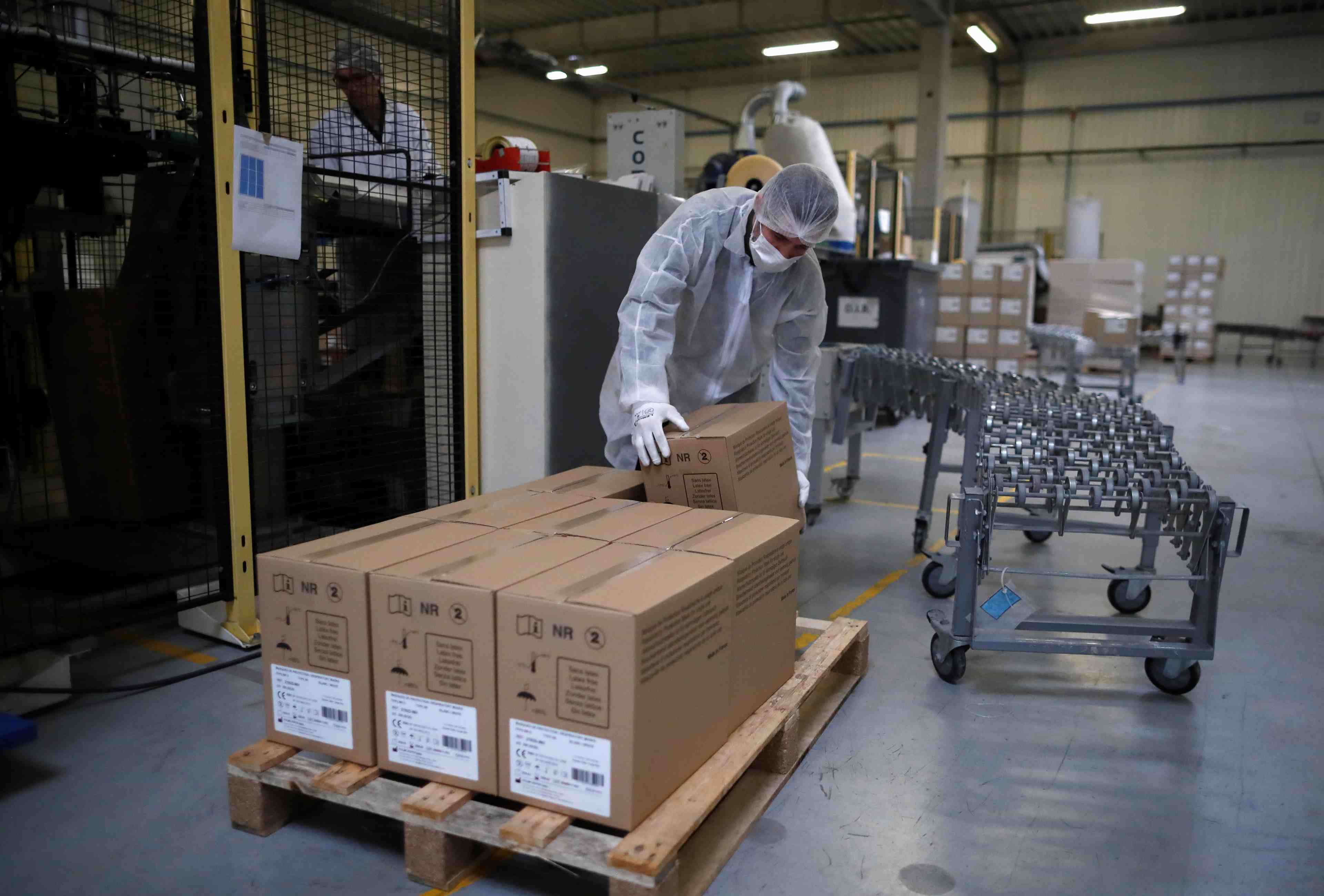 An employee wearing a protective mask works at the kolmi-hopen company's factory in saint-barthelemy-d'anjou