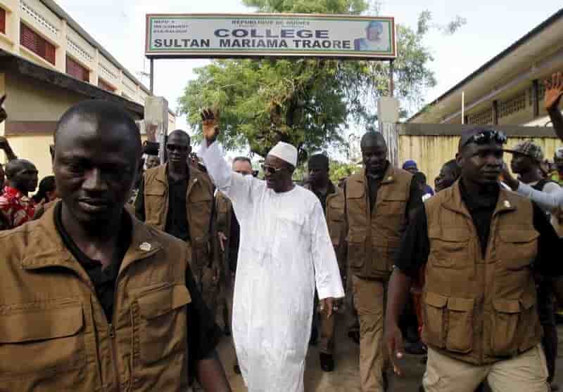 Incumbent president alpha conde, leader of rassemblement du peuple de guinea, wavess as he leaves the polling station during a presidential election in conakry