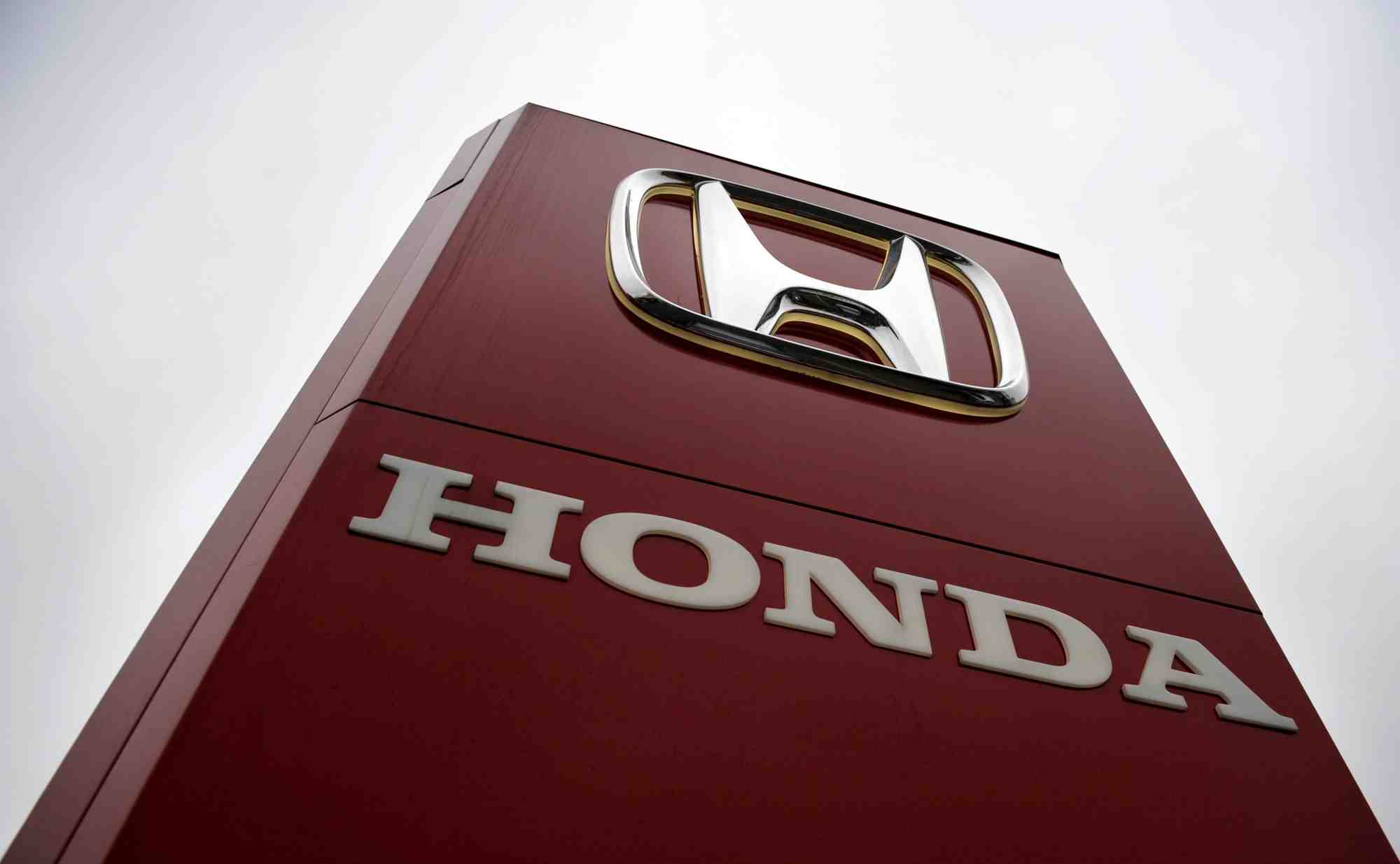 A honda sign is seen outside a dealership in ottershaw, southern england