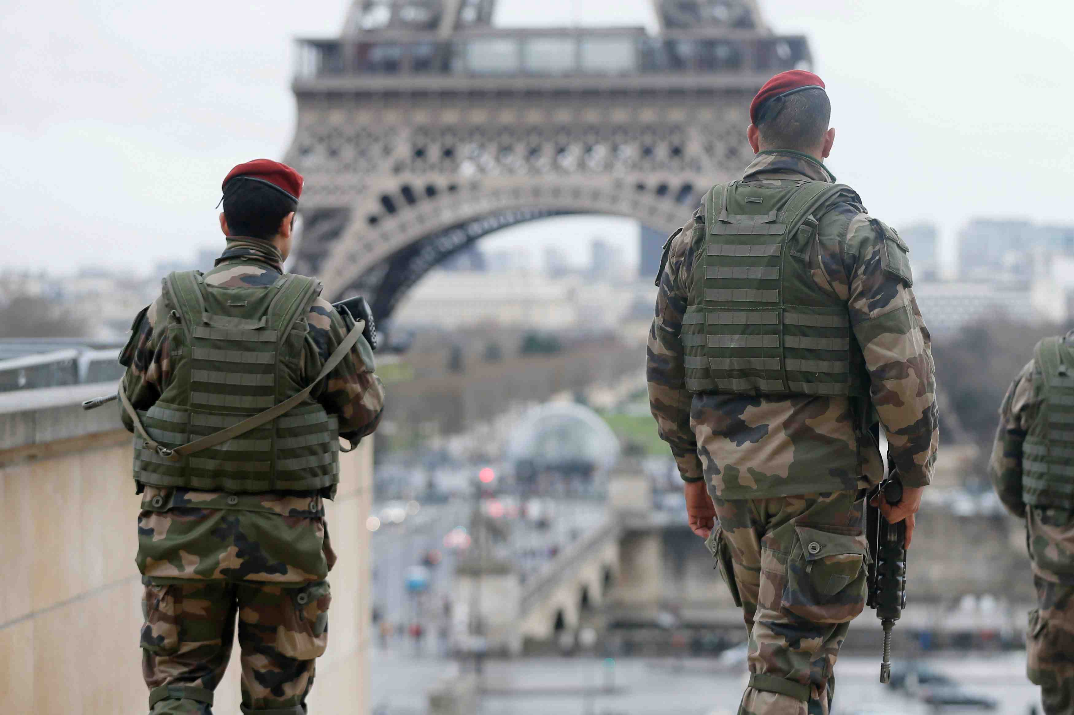 French soldier patrols near the eiffel tower in paris as part of the highest level of "vigipirate" security