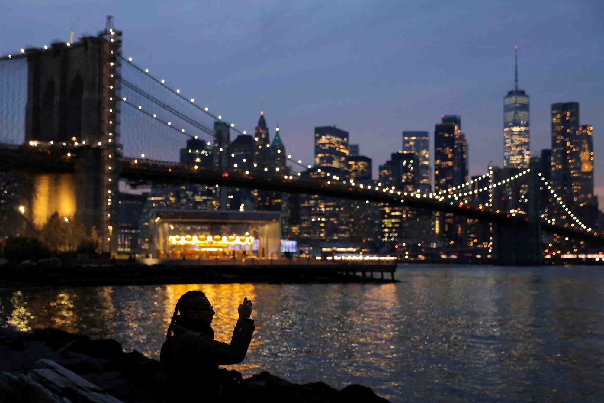 Une personne prend une photo en regardant la ligne d'horizon de manhattan