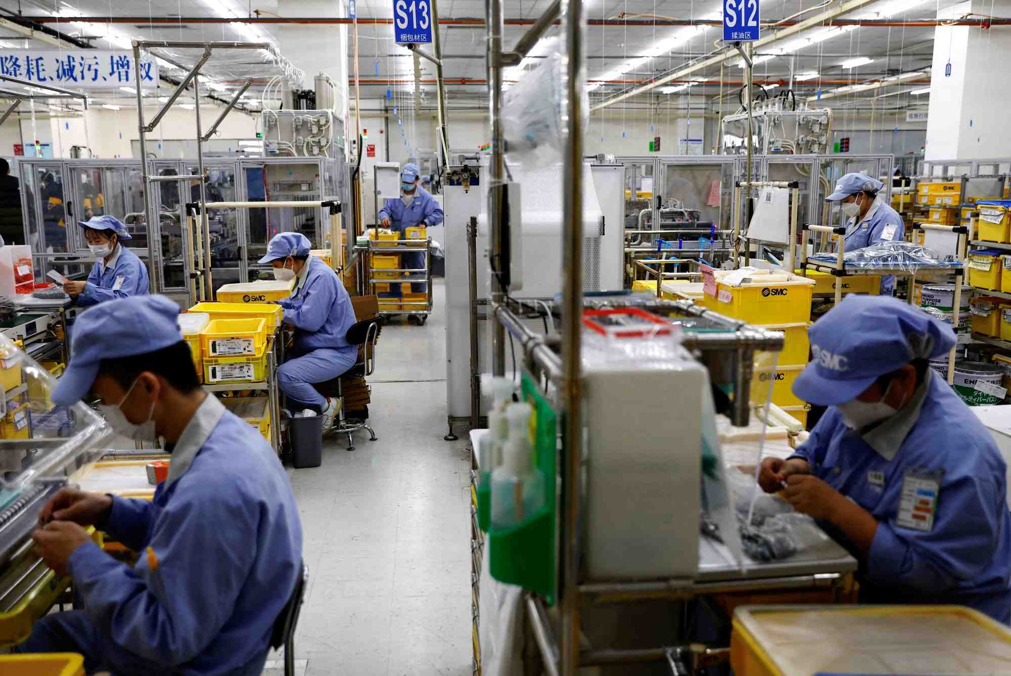 Des employes travaillent dans une usine a pekin, en chine