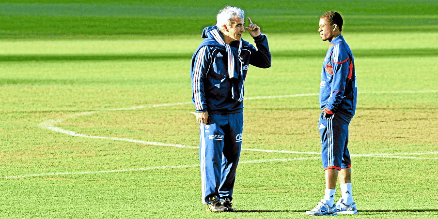 France's coach Raymond Domenech (L) speaks with captain Patrice Evra (R) on the pitch where the team was supposed to be training at the Fields of Dreams stadium in Knysna on June 20, 2010 during the 2010 World Cup football tournament. France's disastrous World Cup campaign was plunged into fresh cha