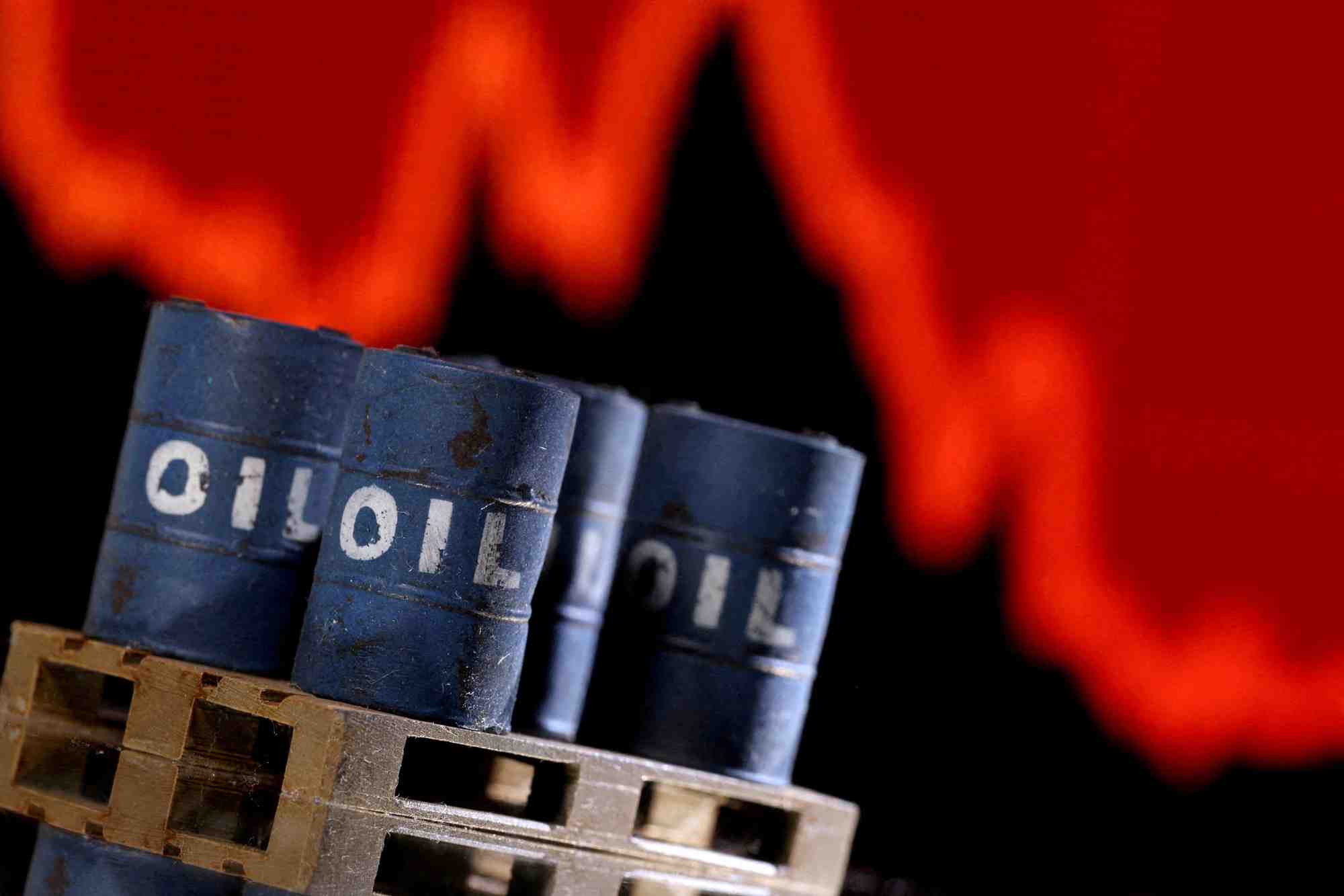 Des barils de petrole imprimes en 3d devant un graphique boursier