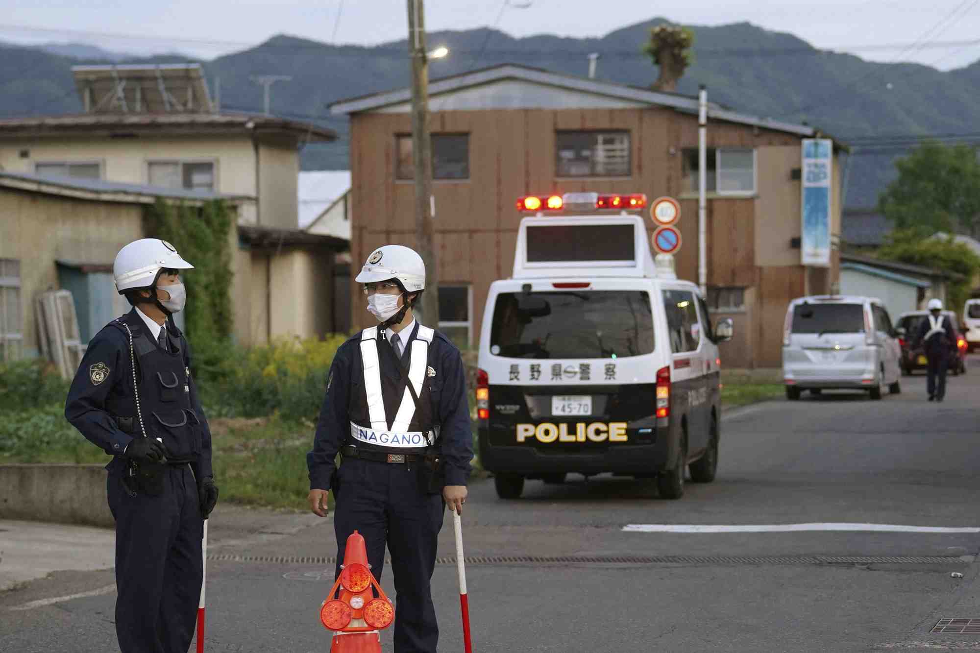 Des policiers se tiennent pres de la scene d'une agression a l'arme blanche et d'une fusillade a nakano