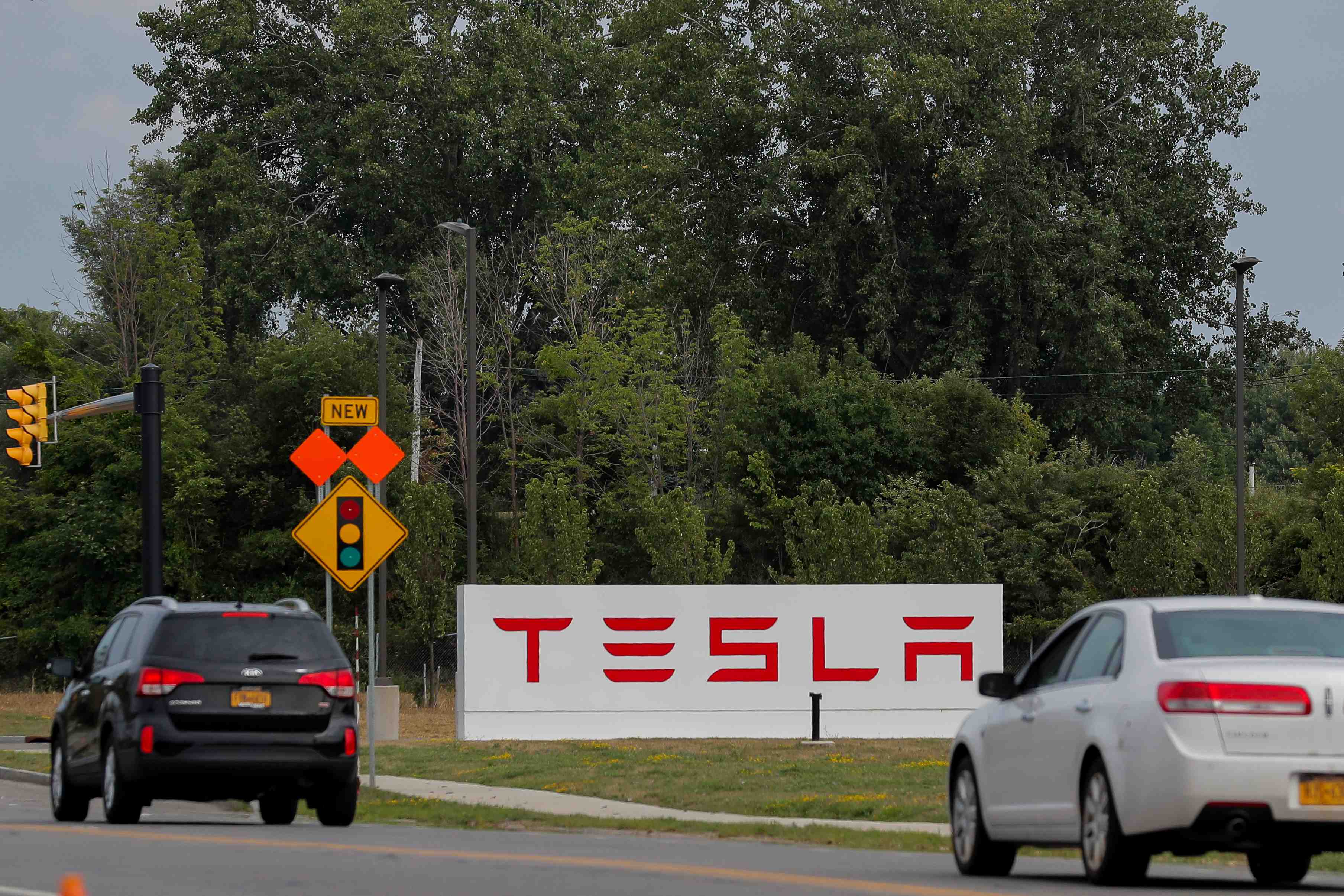 Cars pass by the tesla inc. gigafactory 2, which is also known as riverbend, a joint venture with panasonic to produce solar panels and roof tiles in buffalo, new york