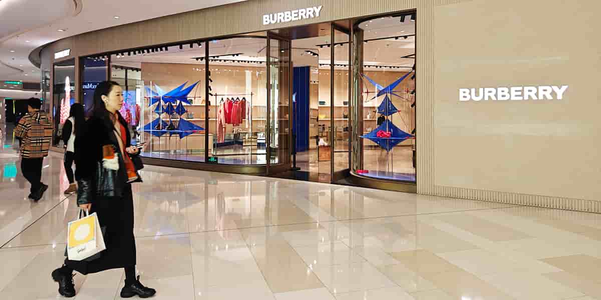 Une cliente passant devant le magasin de luxe Burberry à Shanghai en Chine, le 10 janvier 2024.