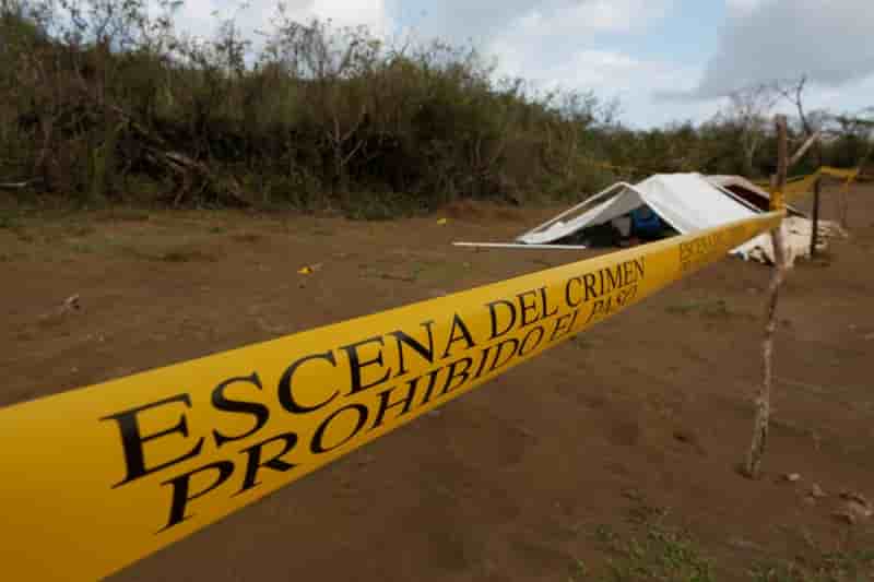 A police cordon marks the perimeter of the site where a forensic team and judicial authorities work in unmarked graves where skulls were found, on the outskirts of veracruz