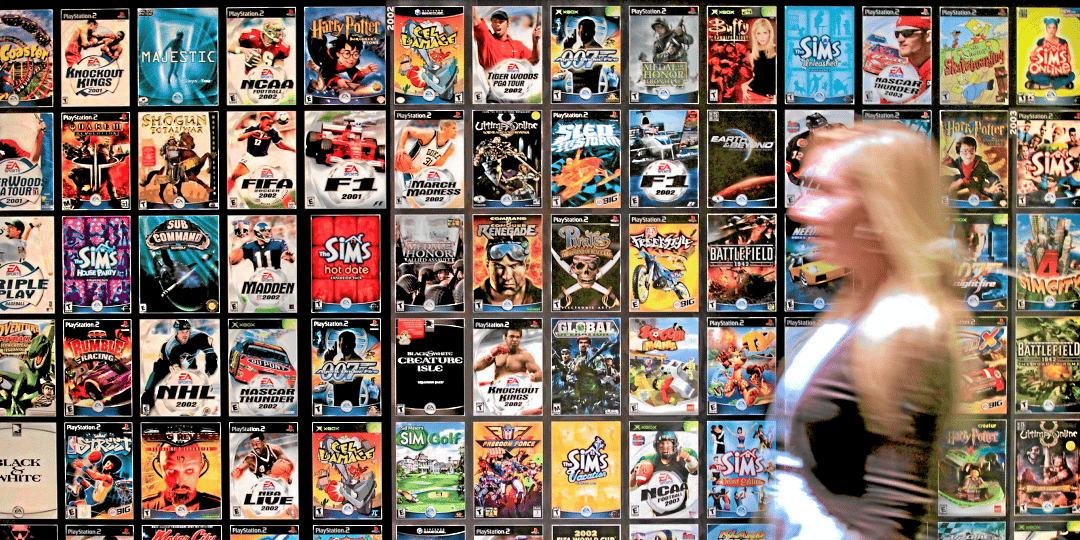 A worker walks past cases for various Electronic Arts Inc. video games at the company's headquarters in Redwood City, California, U.S., on Tuesday, July 20, 2010. Electronic Arts, the world's second-biggest video-game publisher, is in the middle of a market shift, moving away from its declining cons
