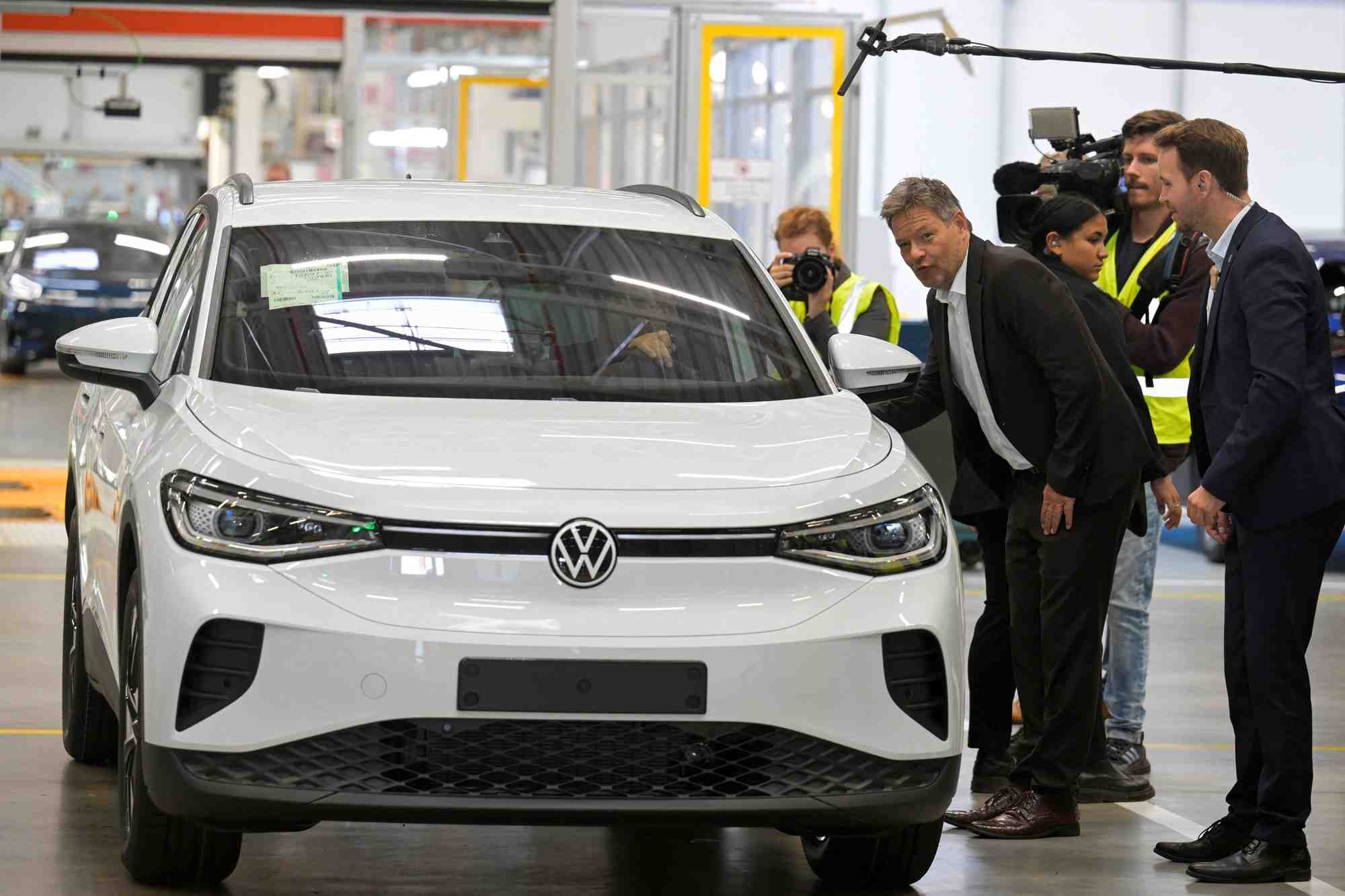 Le ministre allemand de l'economie, robert habeck, pose a cote d'une voiture volkswagen lors de sa visite a l'usine volkswagen a emden