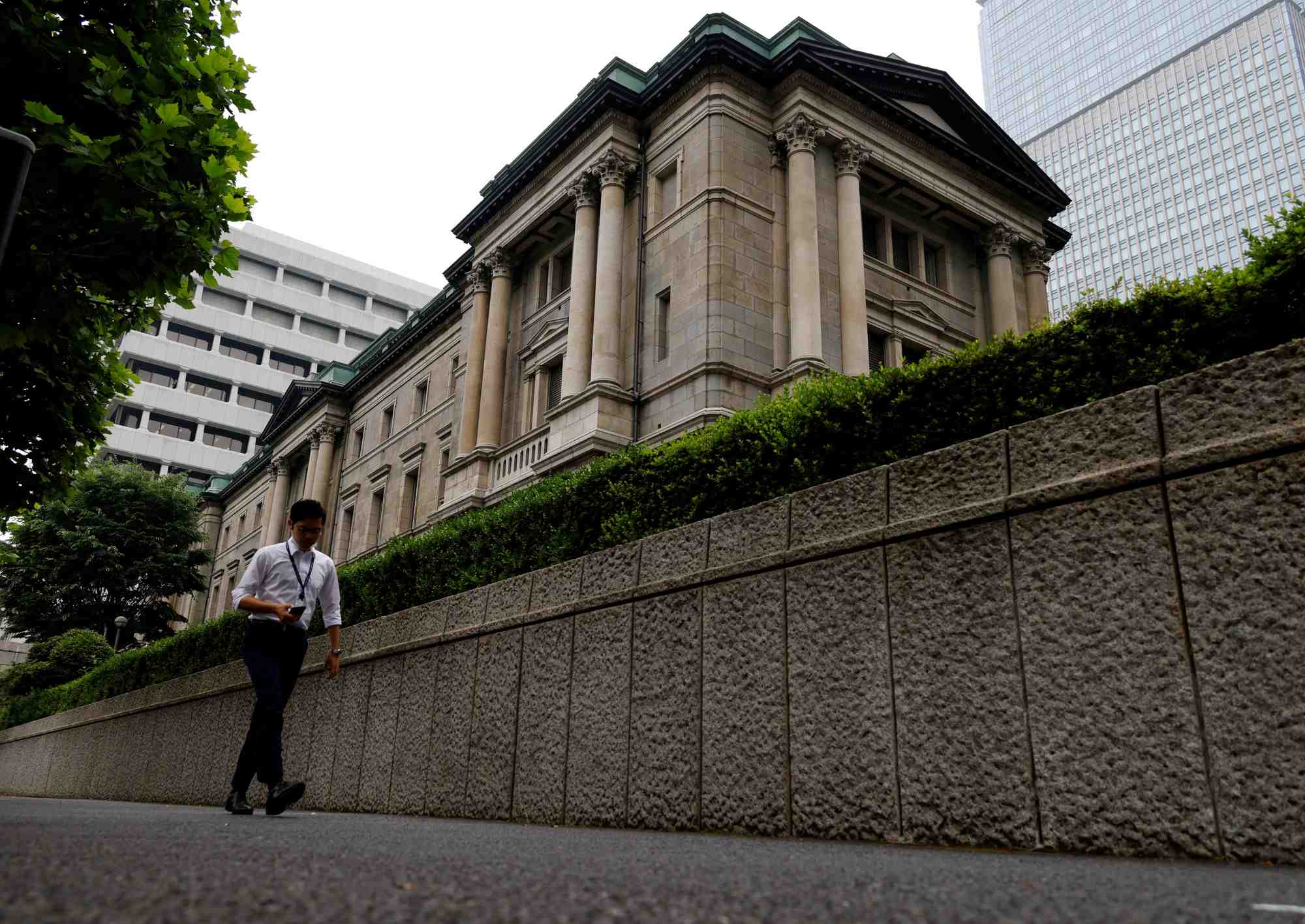 Un homme passe devant le siege de la banque du japon a tokyo
