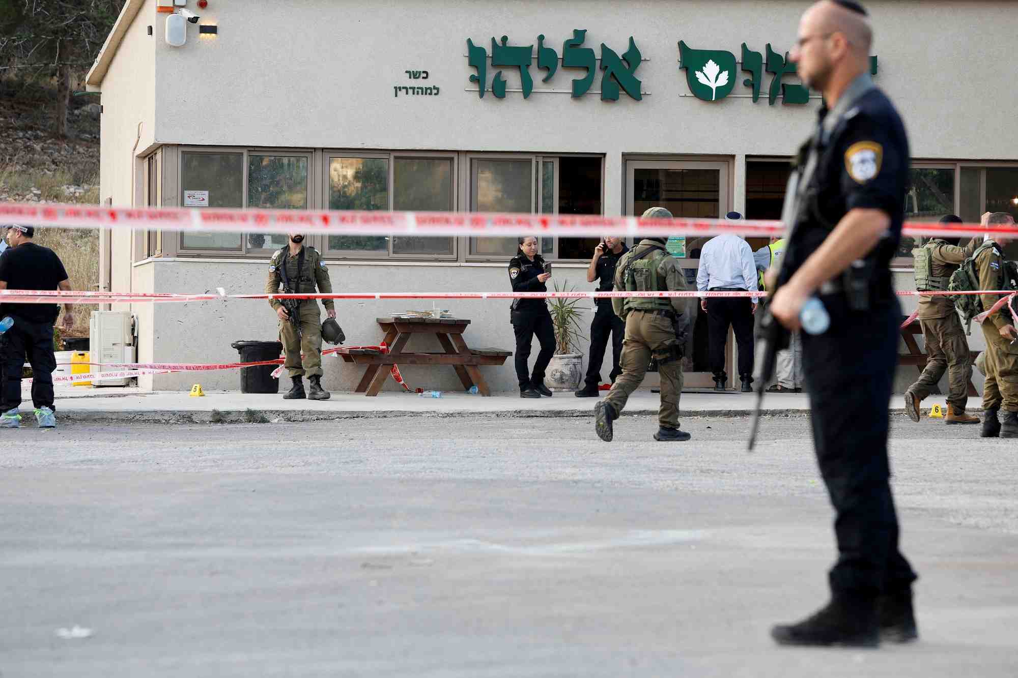 Le personnel de securite travaille sur les lieux d'une attaque menee par deux palestiniens qui a tue quatre personne pres d'une colonie de peuplement juif en cisjordanie occupee
