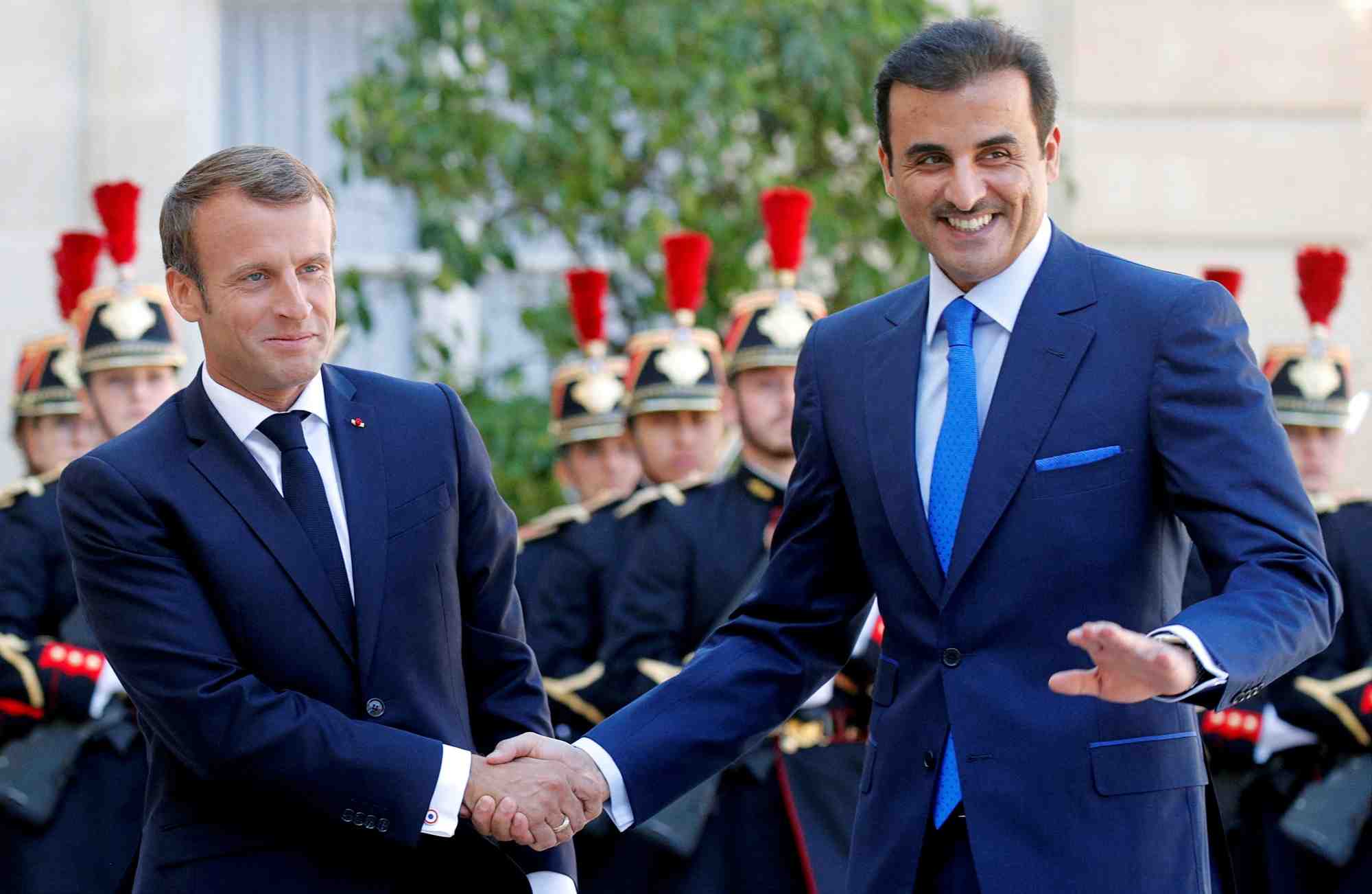 Le president francais emmanuel macron serrant la main de l'emir du qatar, cheikh tamim bin hamad al-thani