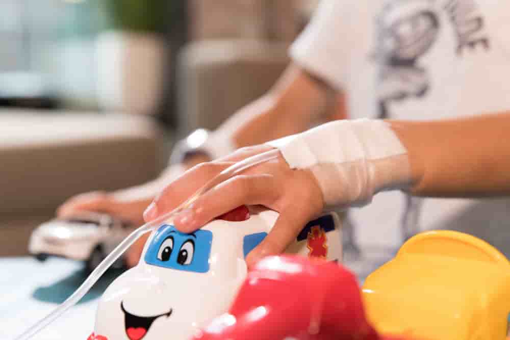 Child playing with toys in hospital with intravenous drip in his hands. Middle East . High quality photo - Child playing with toys in hospital with intravenous drip in his hands. Middle East - Child playing with toys in hospital with intravenous drip...