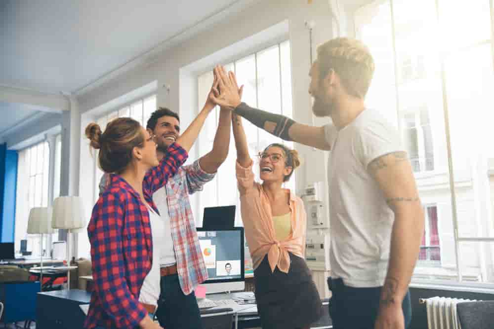 Laughing young business entrepreneurs celebrating a success