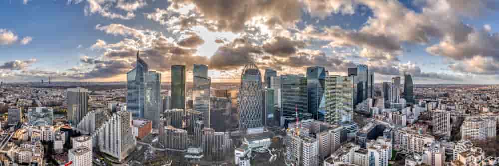 Paris, France - December 09, 2019: Aerial panoramic drone shot of La Defense skycraper with park diderot in Paris with clouds before sunset - Paris, France - December 09, 2019: Aerial panoramic drone shot of La Defense skycraper in Paris with clouds...