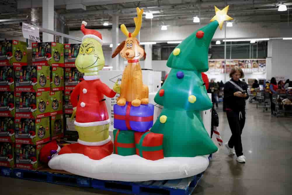 A shopper uses a mobile phone at a Costco store ahead of Black Friday in Arlington, U.S., November 27, 2024. REUTERS/Benoit Tessier - Shoppers at a Costco store ahead of Black Friday in Arlington - RETAIL-HOLIDAYSHOPPING/BLACK FRIDAY