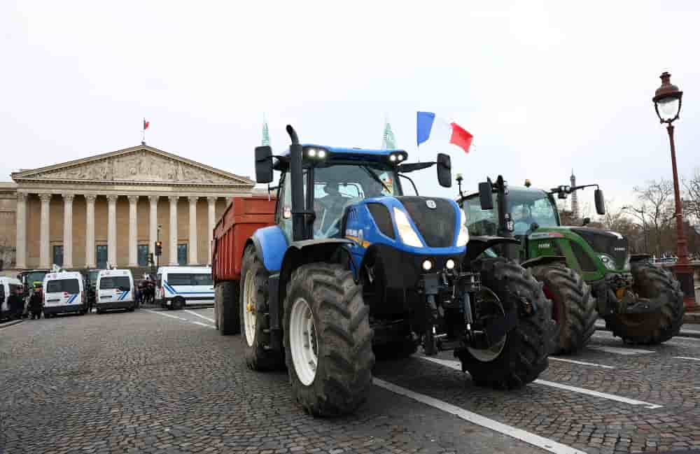 French farmers of French farm unions FNSEA and Jeunes Agriculteurs drive their tractors on the Pont de la Concorde bridge in front of the National Assembly to unlaod tons of potatoes as they protest against the EU-Mercosur free trade agreement and the...