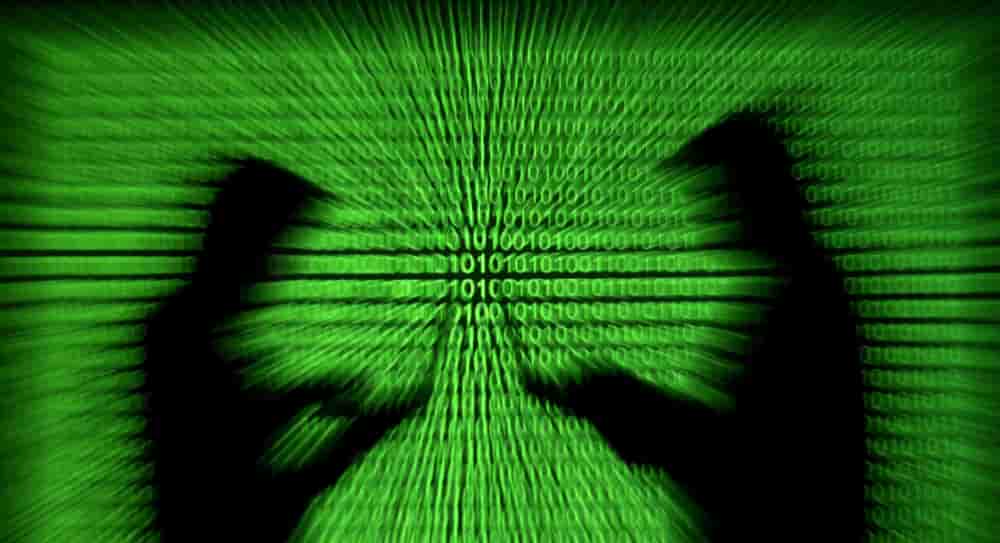 FILE PHOTO: Silhouettes of laptop users are seen next to a screen projection of binary code are seen in this picture illustration created on March 28, 2018. REUTERS/Dado Ruvic/Illustration/File Photo - FILE PHOTO: Silhouettes of laptop users are seen...