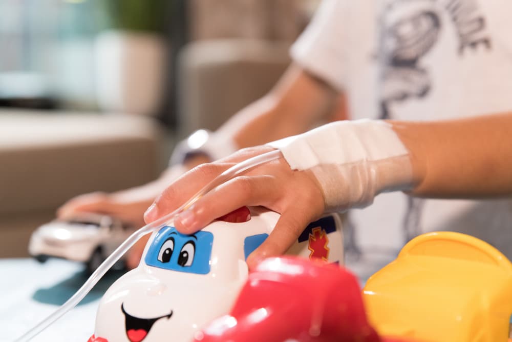 Child playing with toys in hospital with intravenous drip in his hands. Middle East . High quality photo - Child playing with toys in hospital with intravenous drip in his hands. Middle East - Child playing with toys in hospital with intravenous drip...