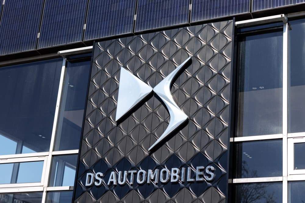 The brand logo of car manufacturer DS Automobiles can be seen on a stele in front of a branch of the company in Munich (Bavaria) on March 20, 2025. DS Automobiles is a French vehicle manufacturer and, since the merger of FCA with PSA, one of the brands...